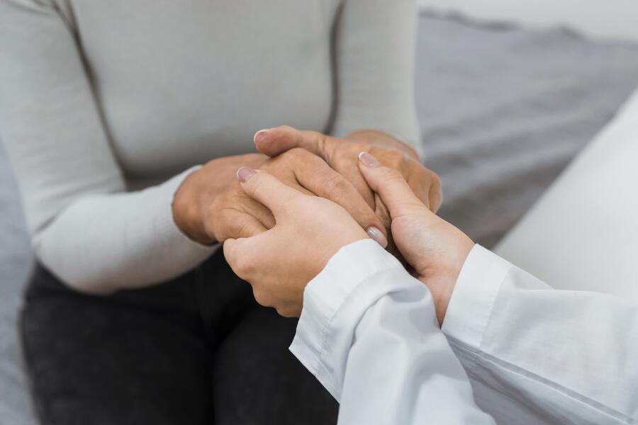 Doctor holding hands with pacient