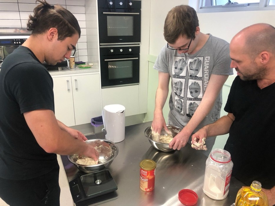 Cooking and baking cohort kneading dough together