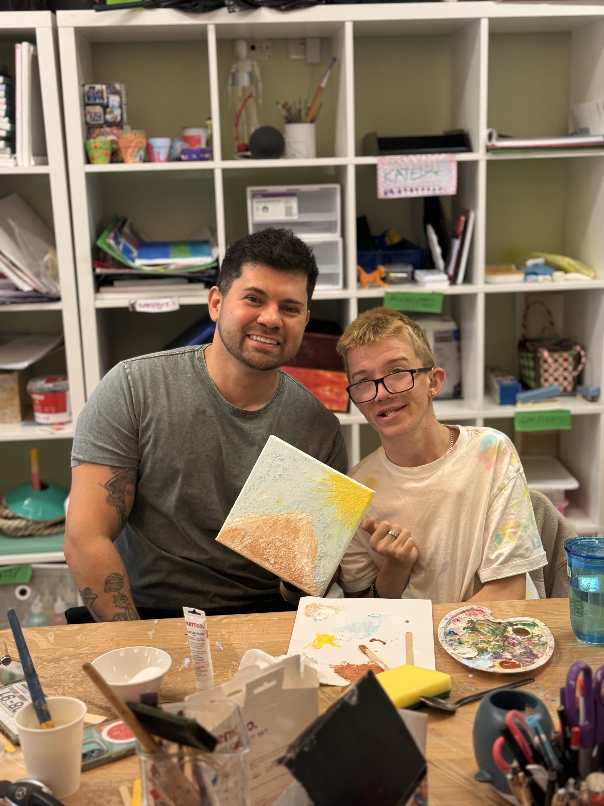 Participants working on a group craft project at YAY Today