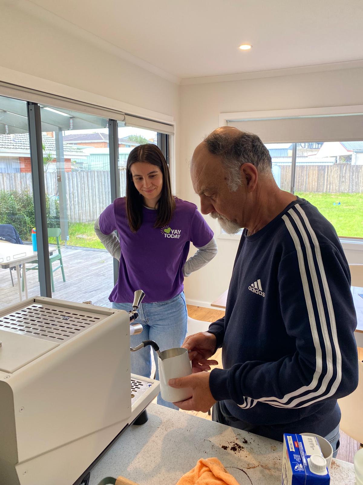 A participant practising on the coffee machine at YAY Today